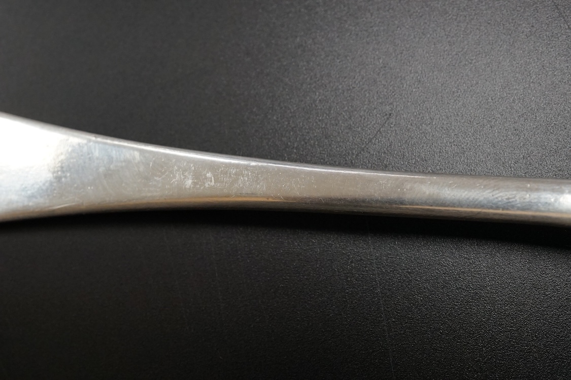 A Queen Anne Britannia standard silver dog nose spoon, indistinct maker's mark, London, 1704, with rat-tail bowl and later? engraved crest, 19.8cm, 63 grams.